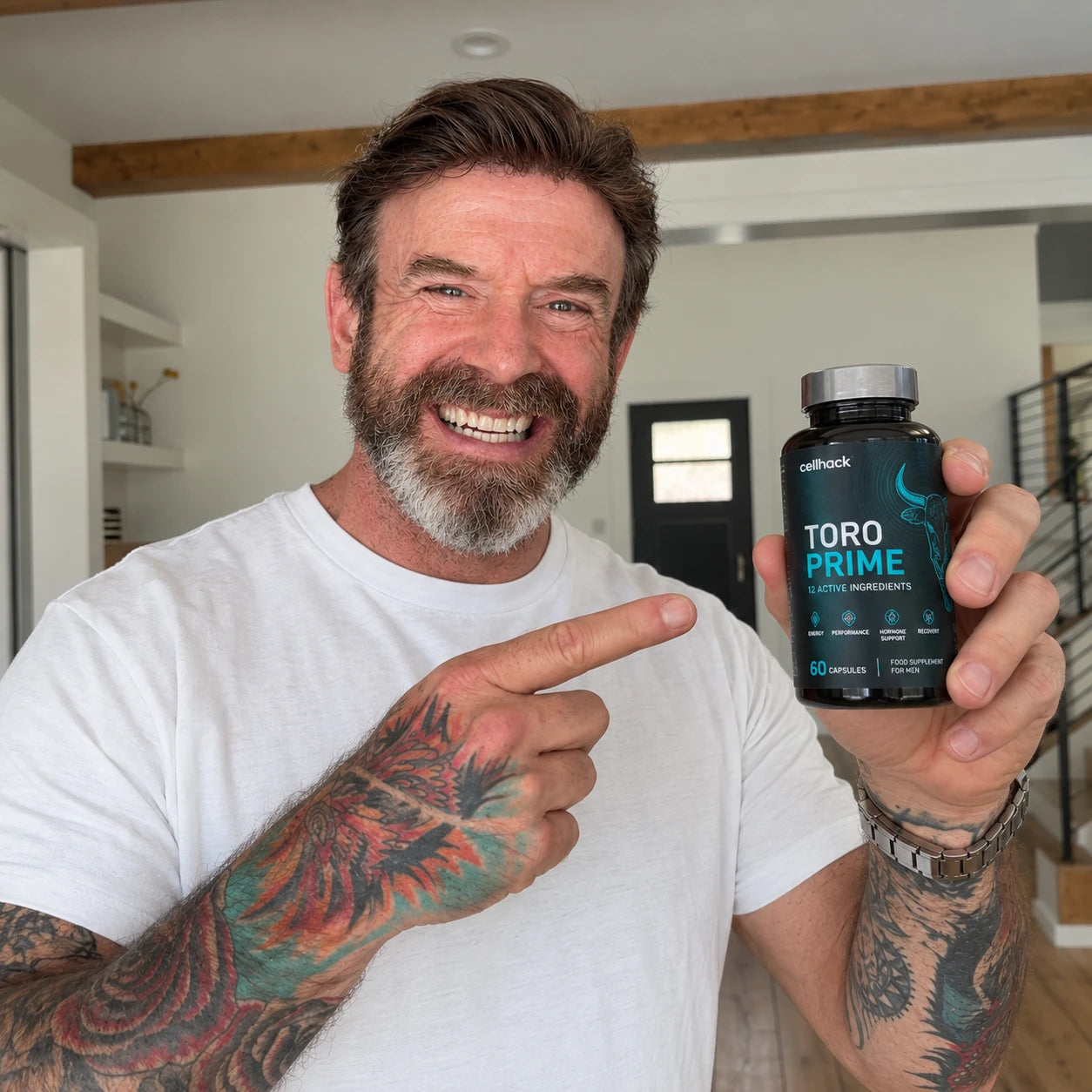 A smiling man pointing at a bottle of Toro Prime