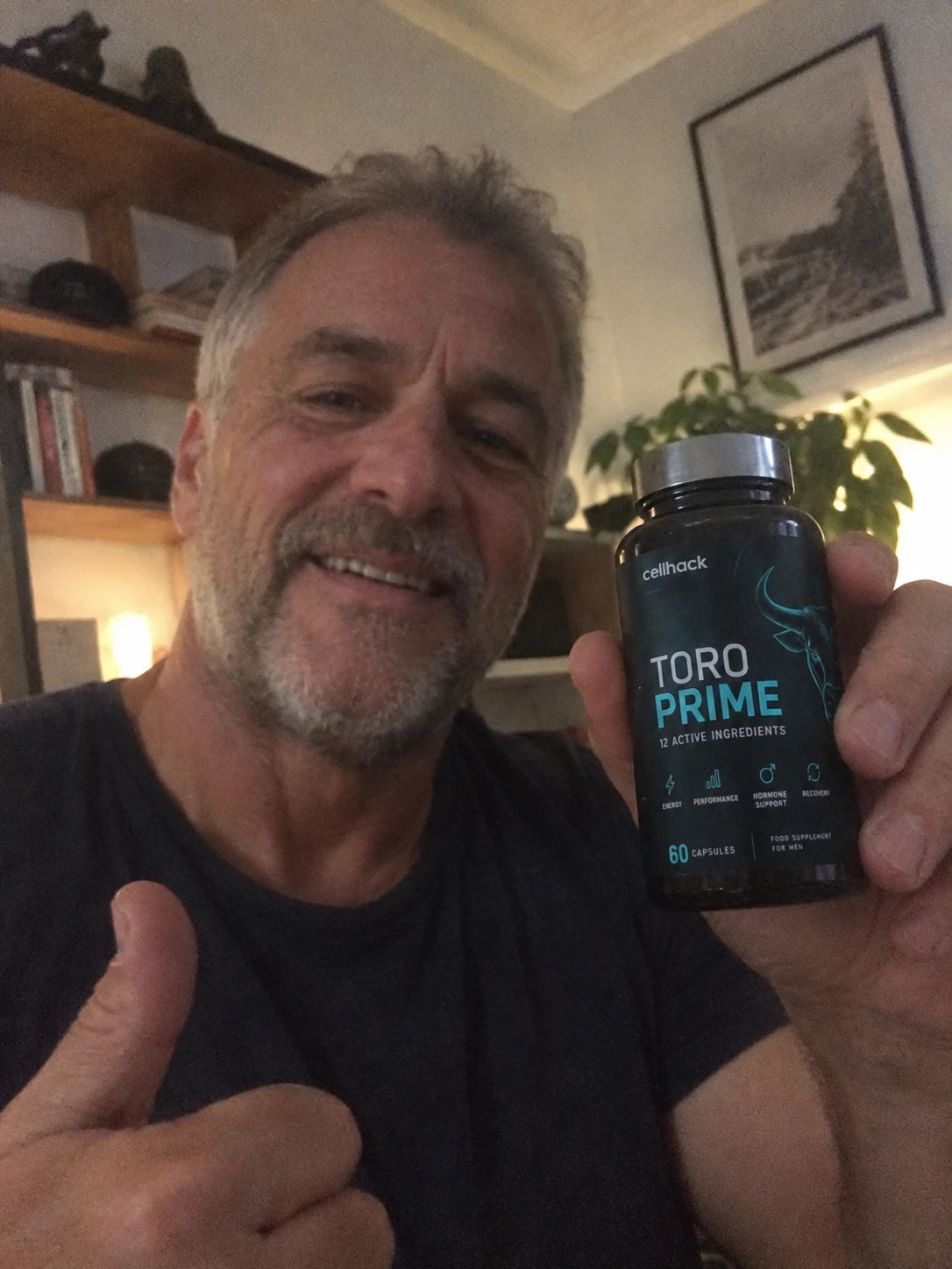 A man giving a thumbs up and holding a bottle of Toro Prime